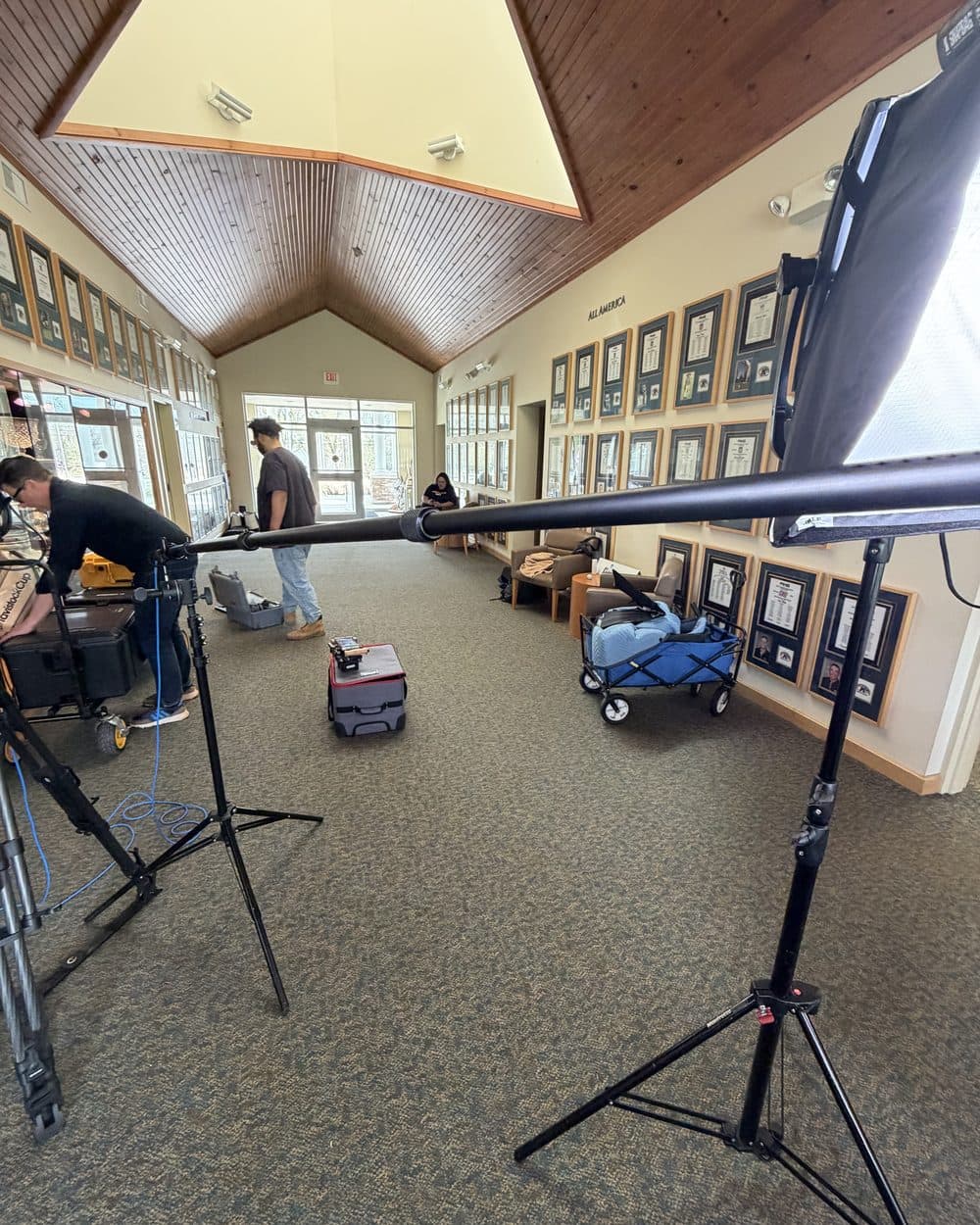 Crew setting up lights in a hallway